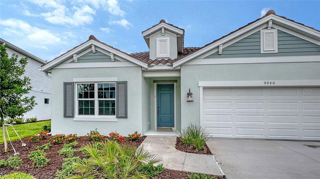 Front exterior of a new home in Grand Park, Sarasota, FL, highlighting curb appeal (Image 2).