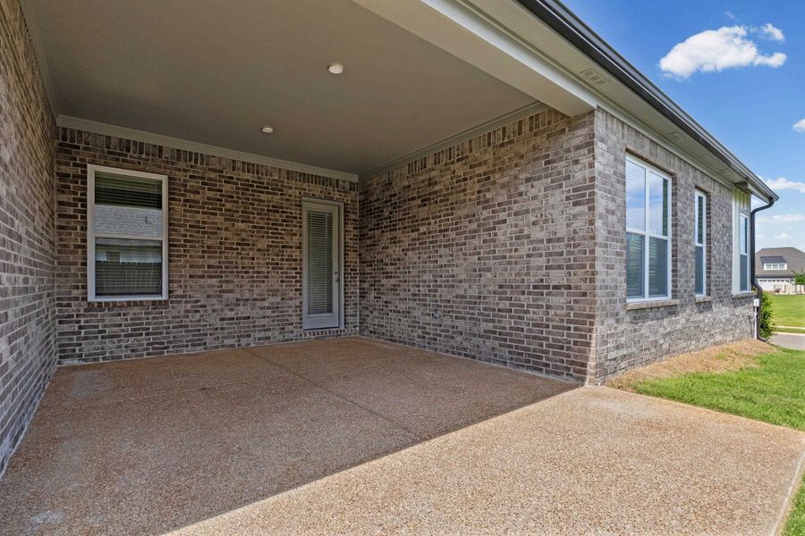 Covered patio featuring an exposed aggregate concrete surface Covered patio featuring an exposed aggregate concrete surface