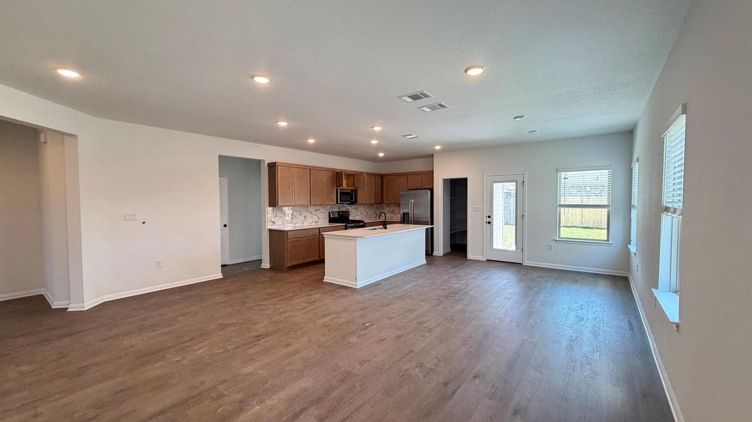An open-concept living area seamlessly connects to a contemporary kitchen, offering both elegance and functionality. An open-concept living area seamlessly connects to a contemporary kitchen, offering both elegance and functionality.