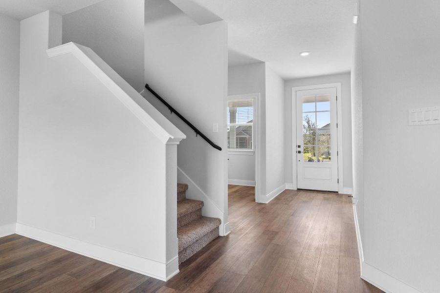 Foyer entrance with stairs and dark wood-type flooring