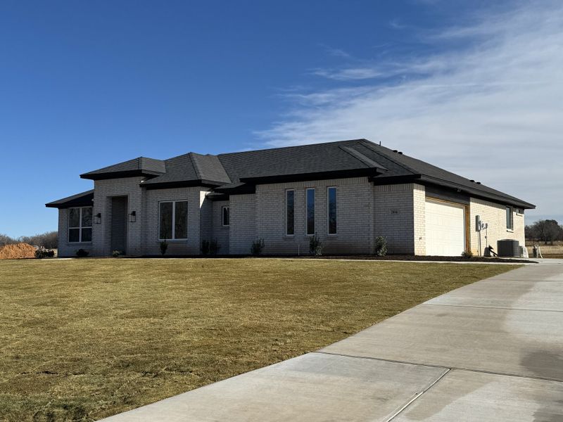 Front exterior of a new home in Taylor Ranch, Springtown, TX, highlighting curb appeal (Image 2).