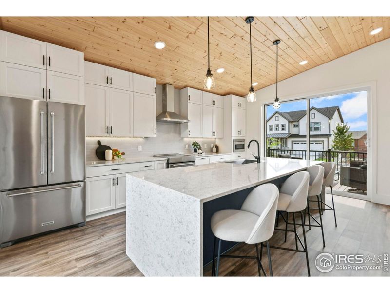Cabinets extend all the way up to the gorgeous vaulted wood ceiling.