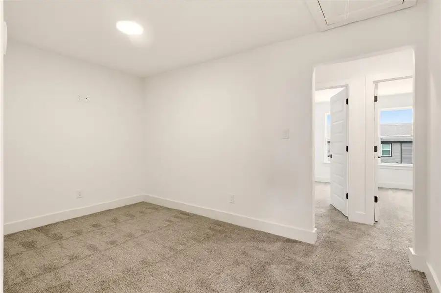 Empty room featuring light colored carpet