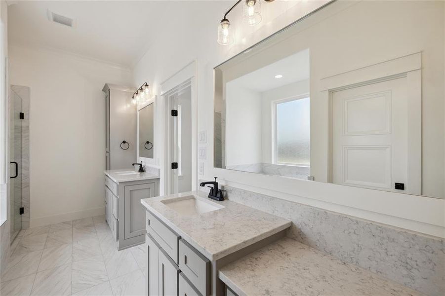 Bathroom featuring vanity and a shower with shower door