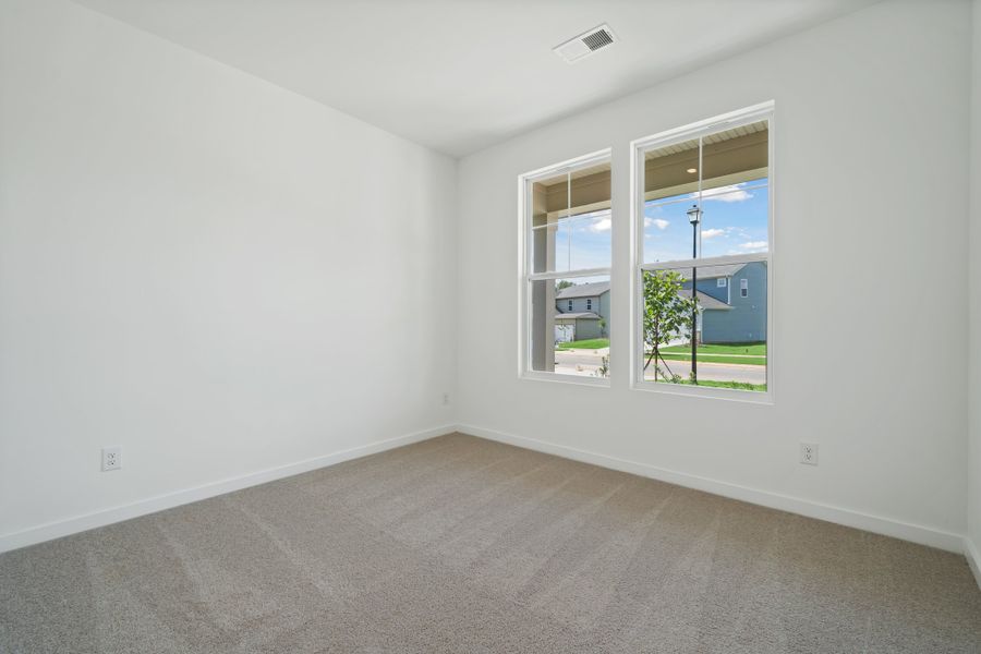 A room with a window and a door with a view of the water.