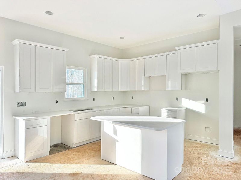 Kitchen layout open & bright. (photo from different home, same design).