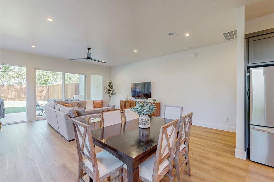 Dining area with light wood-type flooring and ceiling fan