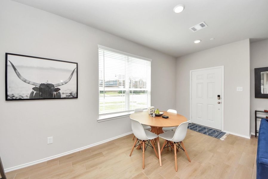Dining space with front door in the distance. Dining space is large enough to also be able to handle a rectangular dining table. Note extra side window that is offered on a corner lot location. Dining space with front door in the distance. Dining space is large enough to also be able to handle a rectangular dining table. Note extra side window that is offered on a corner lot location.