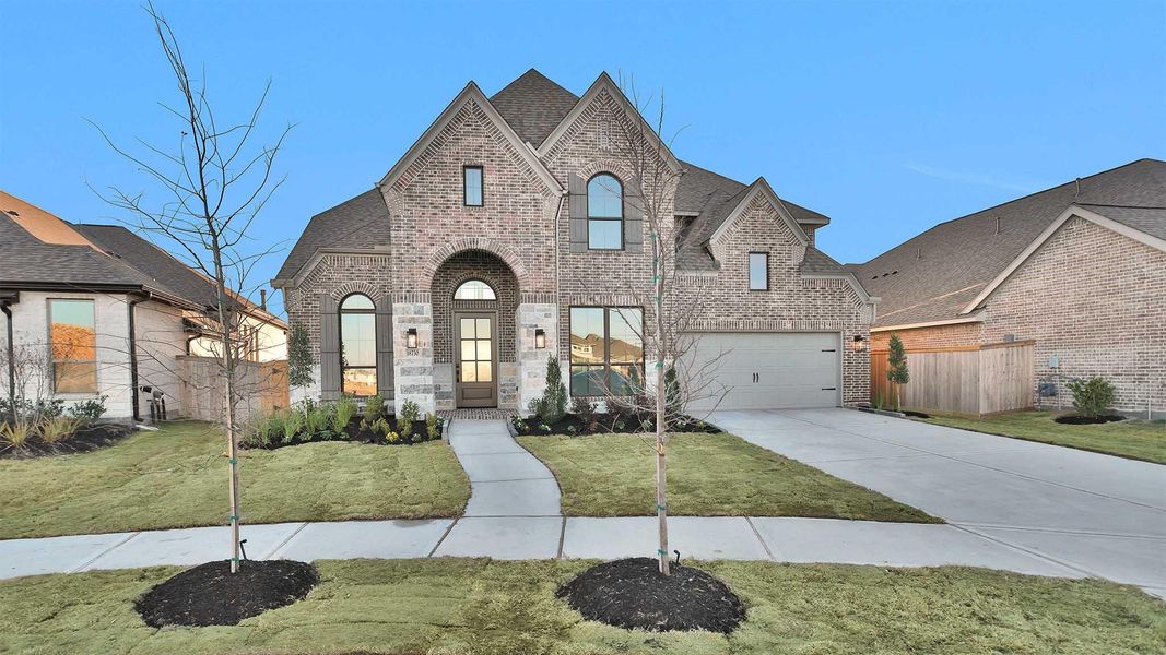 Front exterior of a new home in Valencia, Manvel, TX, highlighting curb appeal (Image 2).
