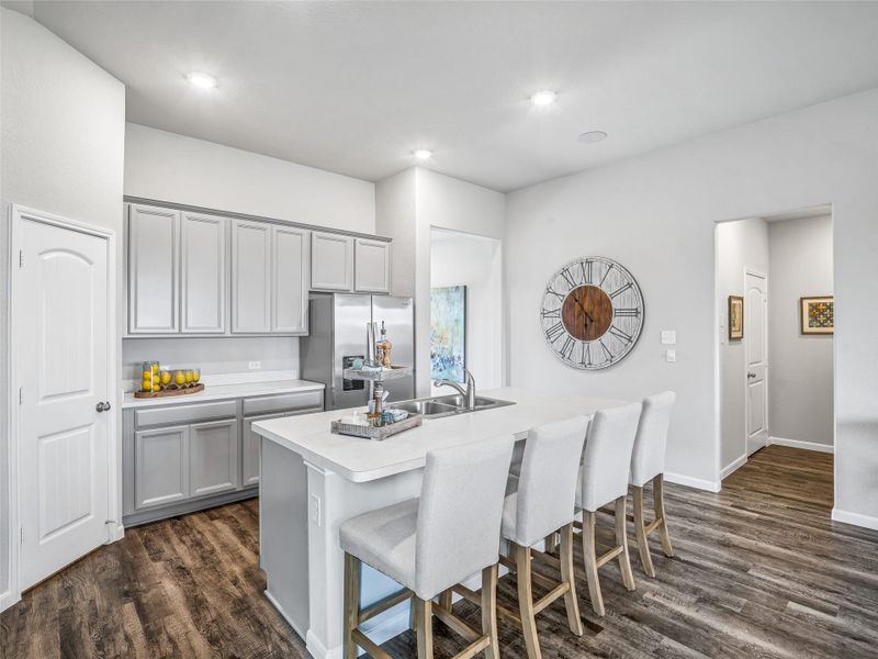 The open concept effortlessly connects the kitchen to the expansive family room, forming a perfect hub for gatherings. This seamless flow creates an inviting space where cooking and socializing come together harmoniously. Sample photo of completed home with similar floor plan. Actual colors and selections may vary. The open concept effortlessly connects the kitchen to the expansive family room, forming a perfect hub for gatherings. This seamless flow creates an inviting space where cooking and socializing come together harmoniously. Sample photo of completed home with similar floor plan. Actual colors and selections may vary.