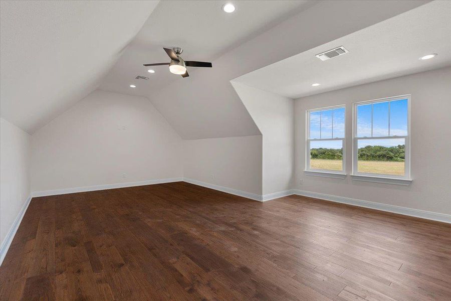 Additional living space featuring dark wood finished floors, vaulted ceiling, recessed lighting, and a ceiling fan