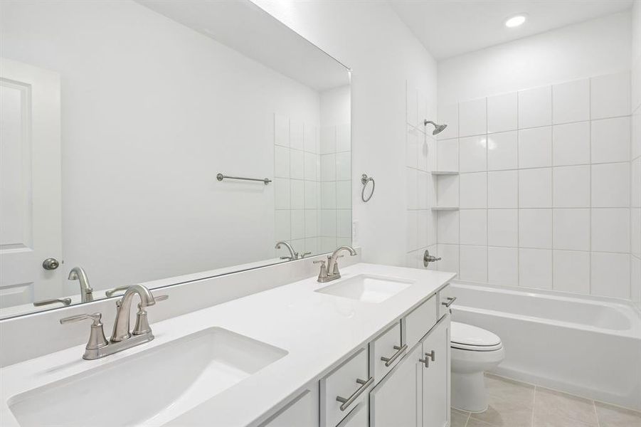 Guests will enjoy their own vanity space in home in this thoughtfully designed and beautifully finished guest bath.