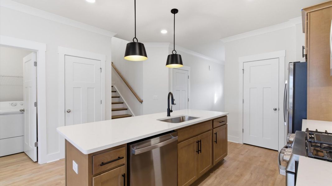 Tasteful kitchen with oversized island and stylish pendant lighting—crafted to high standards