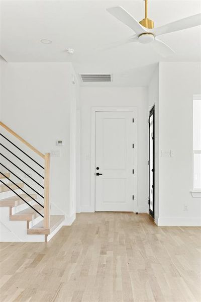 Entrance foyer with light wood-type flooring and ceiling fan