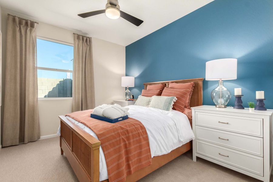 A bedroom with a large window. A bedroom with a large window.