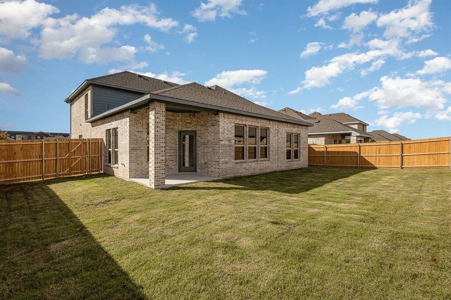 Back of house featuring a patio area and a yard