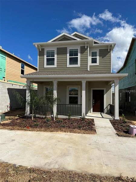 Front exterior of a new home in Wellness Ridge: Cottage Collection, Clermont, FL, highlighting curb appeal (Image 2). Front exterior of a new home in Wellness Ridge: Cottage Collection, Clermont, FL, highlighting curb appeal (Image 2).