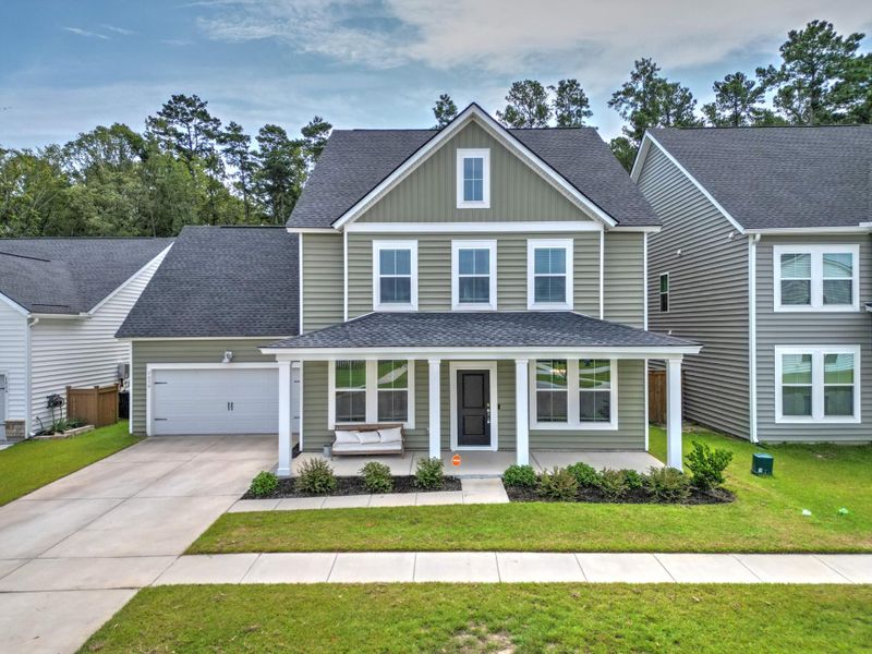 Front exterior of a new home in Sweetgrass at Summers Corner, Summerville, SC, highlighting curb appeal (Image 2). Front exterior of a new home in Sweetgrass at Summers Corner, Summerville, SC, highlighting curb appeal (Image 2).