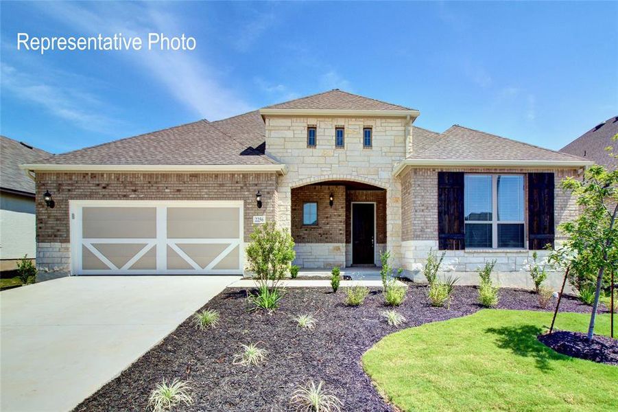 French country inspired facade with stone siding, brick siding, a porch, roof with shingles, and an attached garage French country inspired facade with stone siding, brick siding, a porch, roof with shingles, and an attached garage
