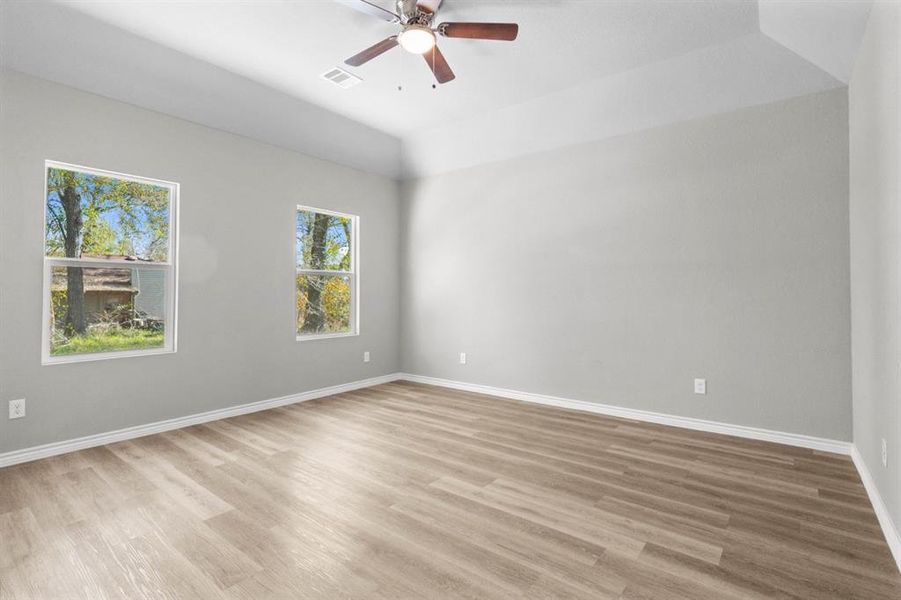 Primary bedroom offers room for big furniture. Notice the attention to detail on the ceiling.  Builder is to add a fence across the backyard which will make the view better and give privacy.