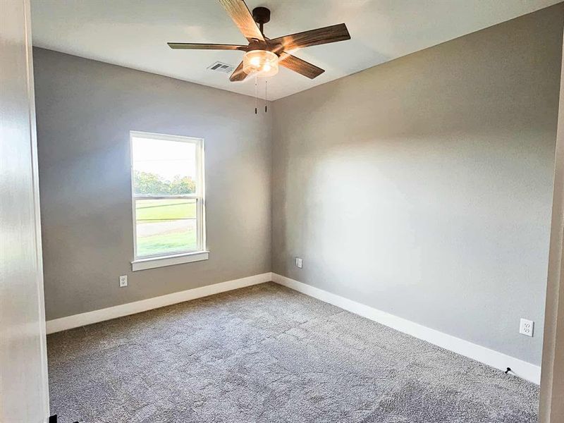 Second bedroom w/ large closet w/ storage shelves.