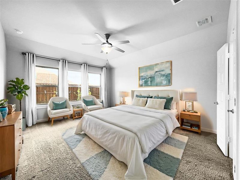 Carpeted bedroom with ceiling fan