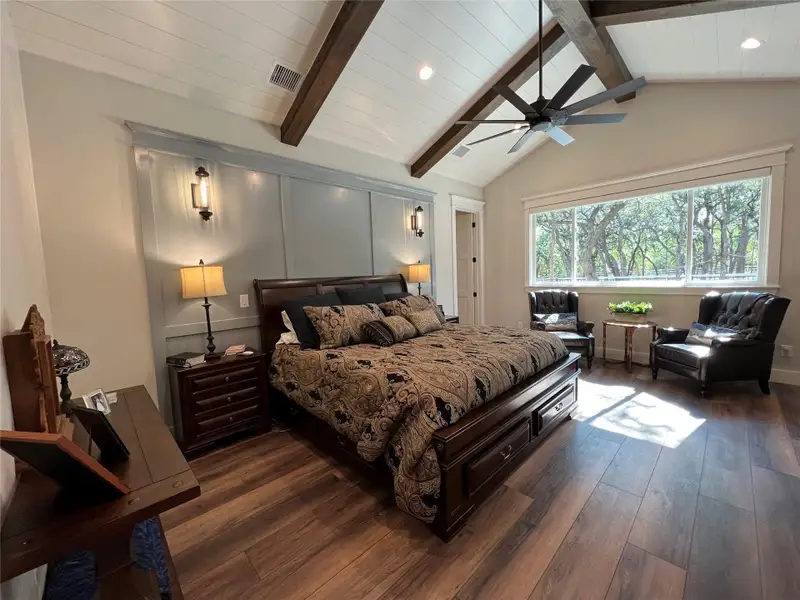 Primary Bedroom luxury vinyl flooring, ceiling fan, and recessed lighting, and sitting area overlooking gorgeous back yard Primary Bedroom luxury vinyl flooring, ceiling fan, and recessed lighting, and sitting area overlooking gorgeous back yard