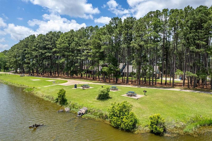 There is an HOA easement between the house and the water.  This HOA easement does not interfere with the privacy of this home.  Very seldom are the tables used.  Golf carts come sometimes and fish.  The path dead ends with an HOA doc.  Also, you can build a doc if you wish.