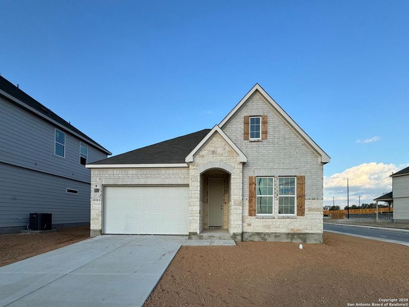 Front exterior of a new home in The Preserve at the Wilder, Adkins, TX, highlighting curb appeal (Image 1).