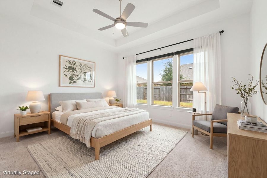 The primary suite is located at the back of the home with views out of the large picture windows. Spacious enough for any size furniture that you may have. The windows have automatic blackout curtains so you can sleep in on a Saturday morning!