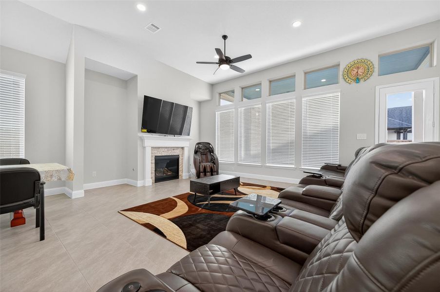 Abundance of natual lignt form the wall of windows in this large open living space, perfect for family fun and entertainment.