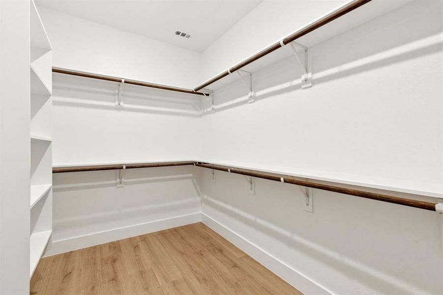 Spacious closet with light wood finished floors Spacious closet with light wood finished floors
