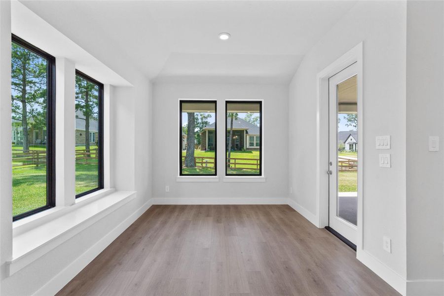 Create lasting memories around the table with family and friends in the dining! It showcases sloped ceilings, large windows, window seat, LVP flooring, and recessed lighting for a warm and welcoming atmosphere.