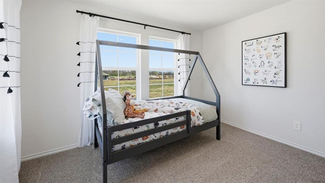 Bedroom with carpet flooring and baseboards Bedroom with carpet flooring and baseboards