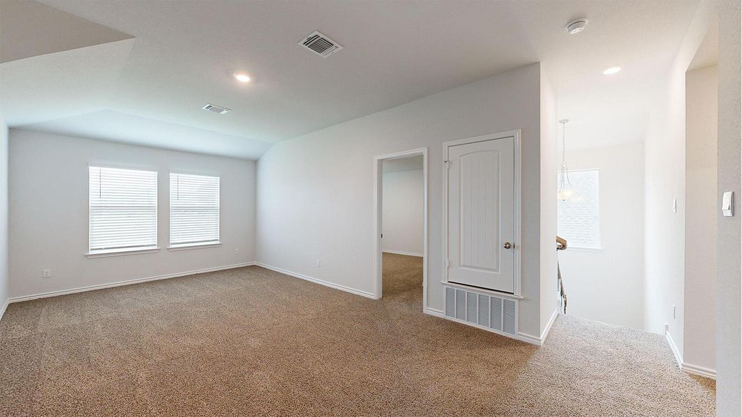 Carpeted room featuring two windows with blinds, recessed lighting, and a white door with a louvered panel Carpeted room featuring two windows with blinds, recessed lighting, and a white door with a louvered panel