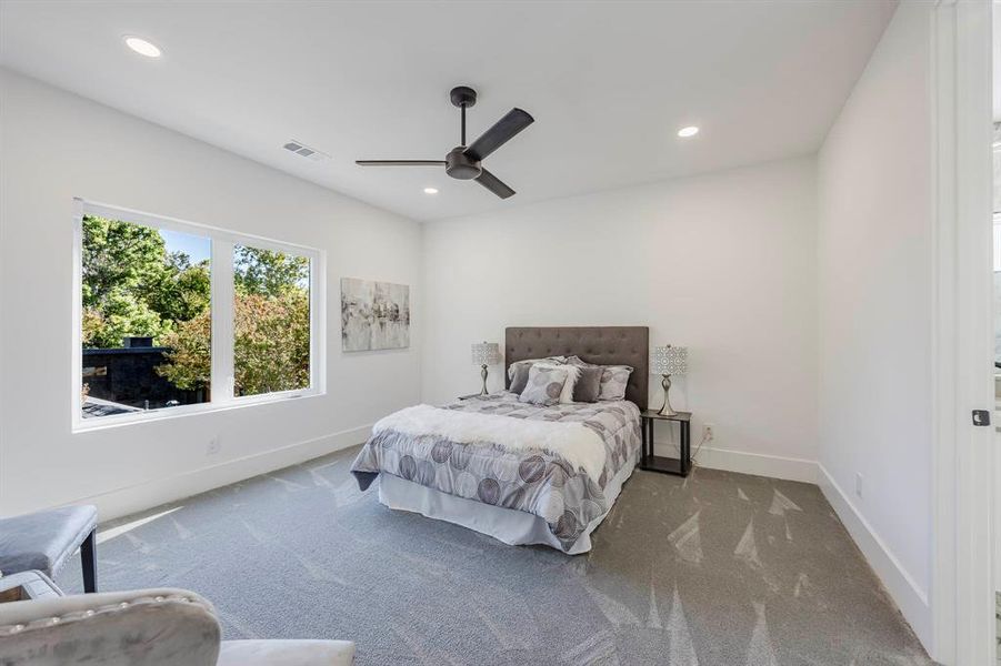 Carpeted bedroom featuring ceiling fan and recessed lighting Carpeted bedroom featuring ceiling fan and recessed lighting
