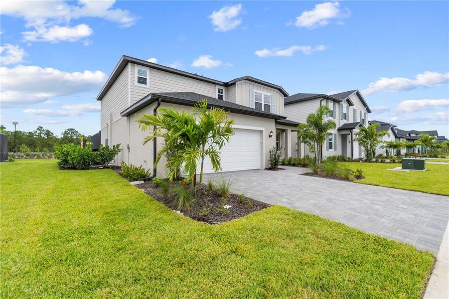 Front exterior of a new home in Sabal Glen at Babcock Ranch, Punta Gorda, FL, highlighting curb appeal (Image 25). Front exterior of a new home in Sabal Glen at Babcock Ranch, Punta Gorda, FL, highlighting curb appeal (Image 25).