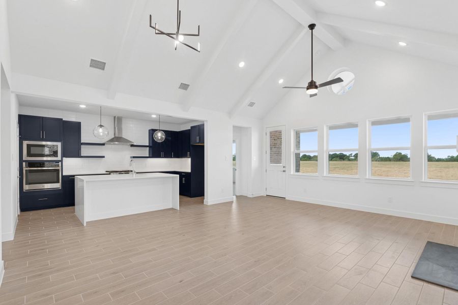 Bright and airy living space with high ceilings and painted beams Bright and airy living space with high ceilings and painted beams