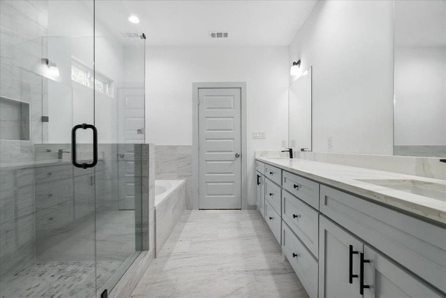 Bathroom with vanity and shower with separate bathtub