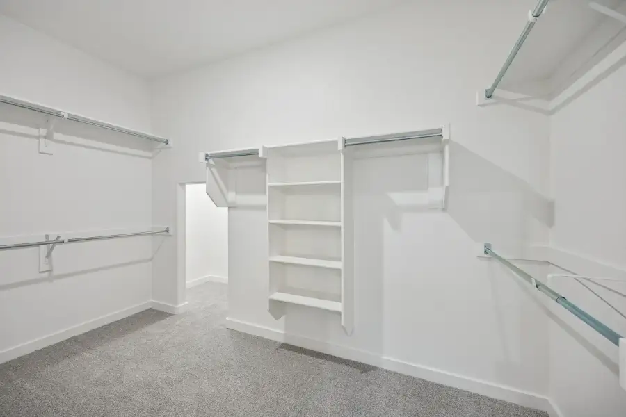 Primary Closet in the Wimbledon home plan by Trophy Signature Homes – REPRESENTATIVE PHOTO Primary Closet in the Wimbledon home plan by Trophy Signature Homes – REPRESENTATIVE PHOTO