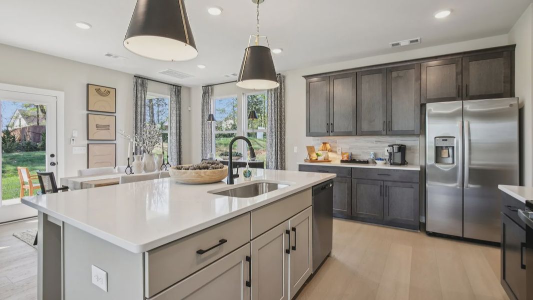 Kitchen with quartz countertops and dark cabinetry