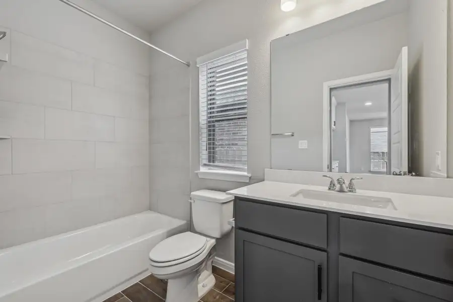 Bathroom with toilet, vanity, and shower / tub combination Bathroom with toilet, vanity, and shower / tub combination