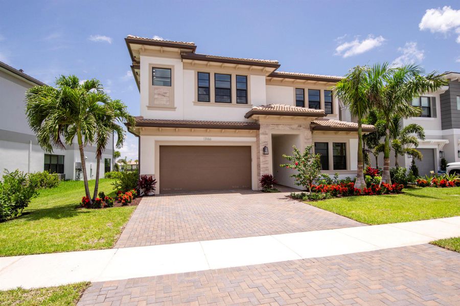 Front exterior of a new home in Apex at Avenir, Palm Beach Gardens, FL, highlighting curb appeal (Image 20).