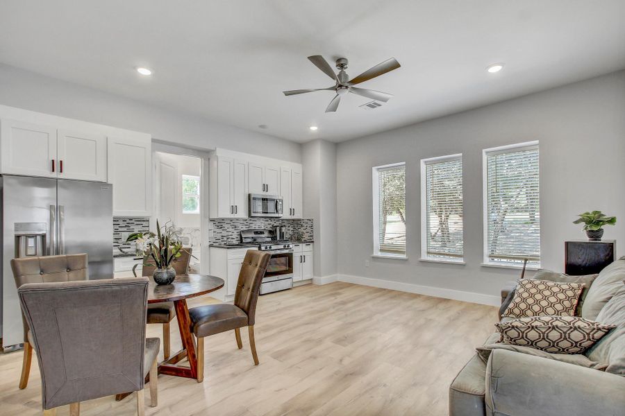 Dining space another refrigerator sink and gas with separate entrance luxury vinyl flooring, a ceiling fan, and recessed lighting
