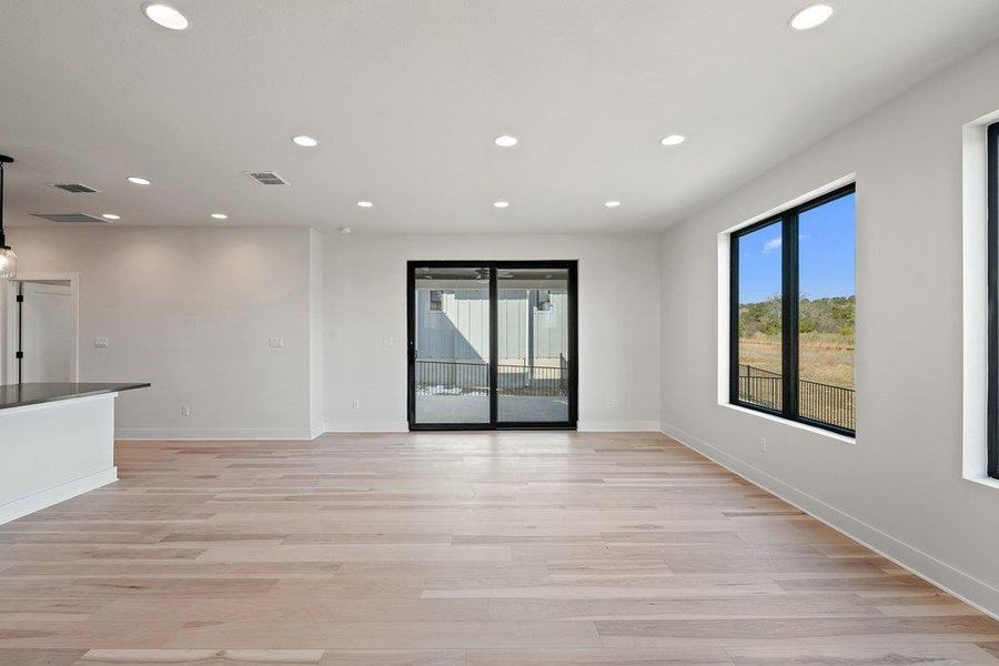 Unfurnished living room featuring light wood-style flooring and recessed lighting