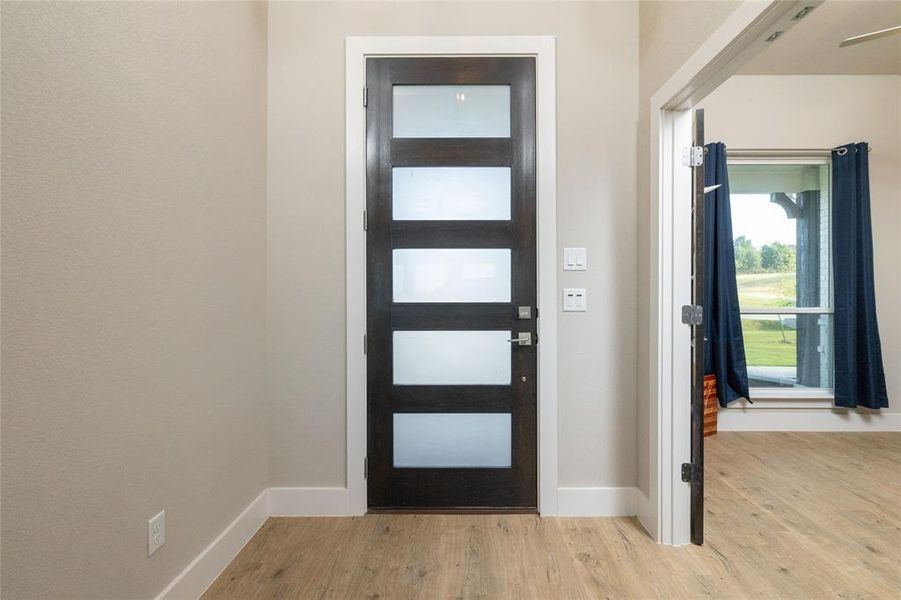 Foyer entrance with light wood-style floors