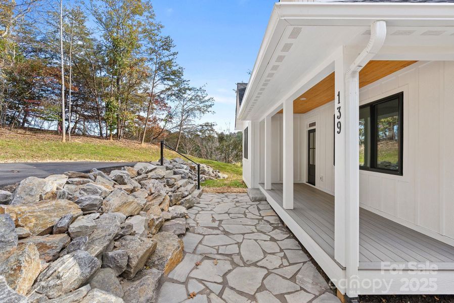 Tennessee Blue Grey Flagstone and a gorgeous stone retaing wall lead to the covered front porch.