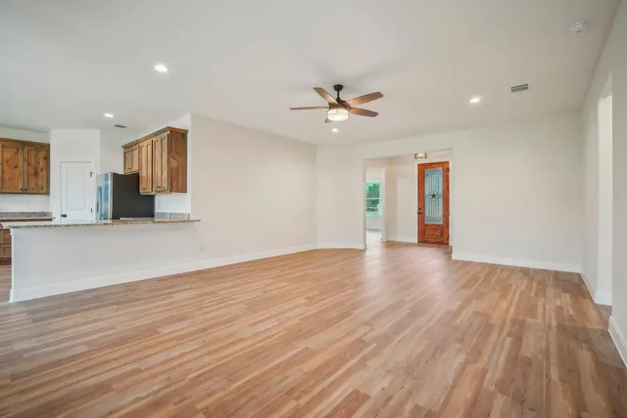 Unfurnished living room featuring visible vents, baseboards, light wood-style flooring, recessed lighting, and ceiling fan