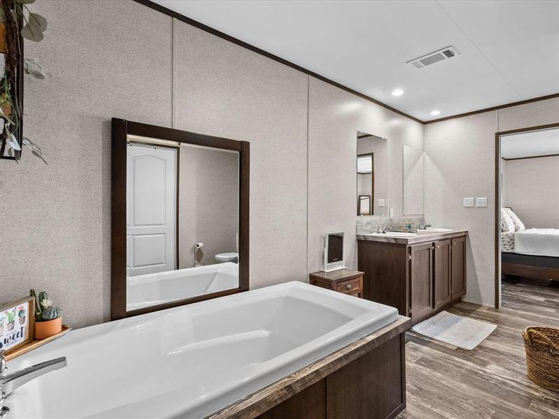 Soaking Tub with a stand up shower and dual vanities.