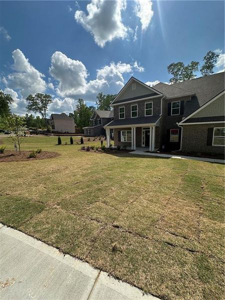 Front exterior of a new home in Mirror Lake at South Harbour, Villa Rica, GA, highlighting curb appeal (Image 23).